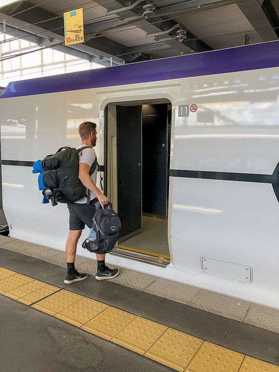 Mark boarding a bullet train in Japan