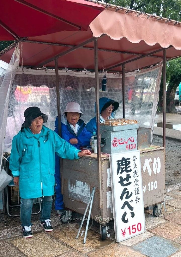 Three ladies selling deer crackers to tourists