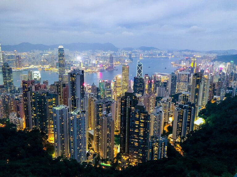 Victoria Peak Hong Kong in dusk as building begin to light up
