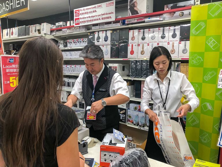 Womn buying her first ever camera in tokyo Japan