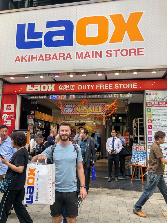 Man outside LAOX with brand new camera in bag