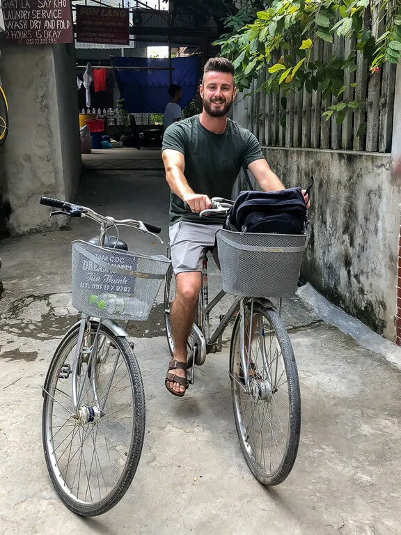 Man on a hire bicycle next to an empty bike in Tam Coc