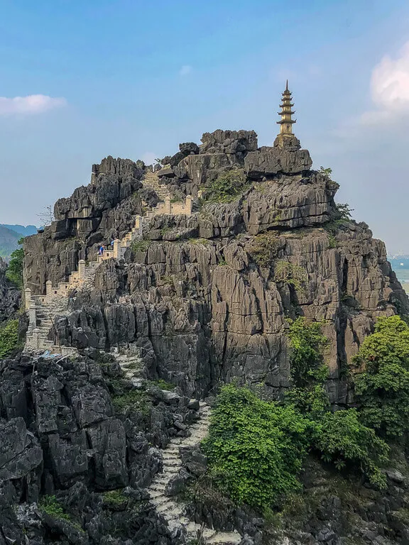 Narrow staircase slalom to pagoda atop rock