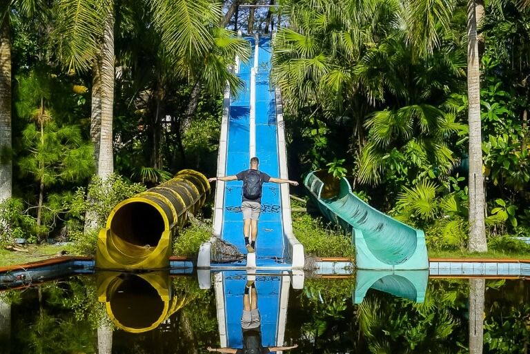 Mark balancing between two water slides at the abandoned park in hue