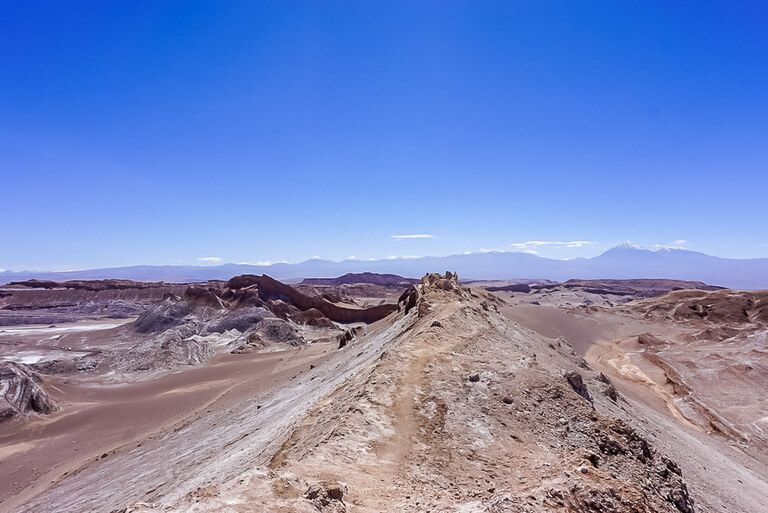 jagged moon like rocks and view over valley in atacama