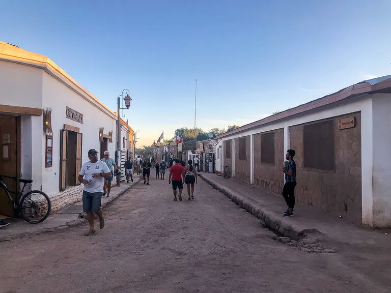 people walking down dirt streets San Pedro de Atacama