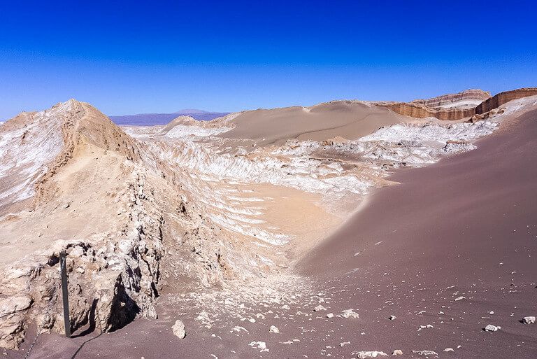 one of best things to do in San Pedro de Atacama is stand on top of san dunes at valle de la luna