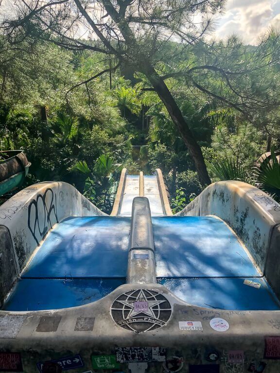 Blue water slide from the top at abandoned park hue
