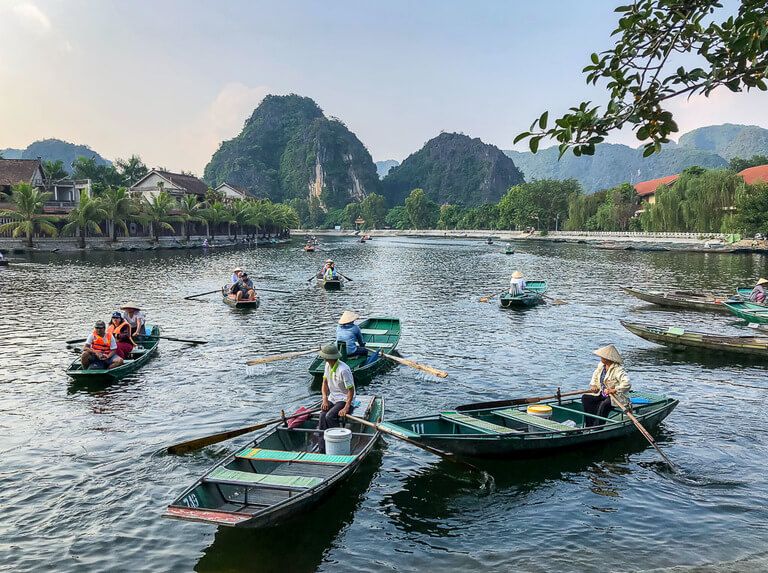 Tam Coc boat tour on Ninh Binh itinerary boats leaving dock