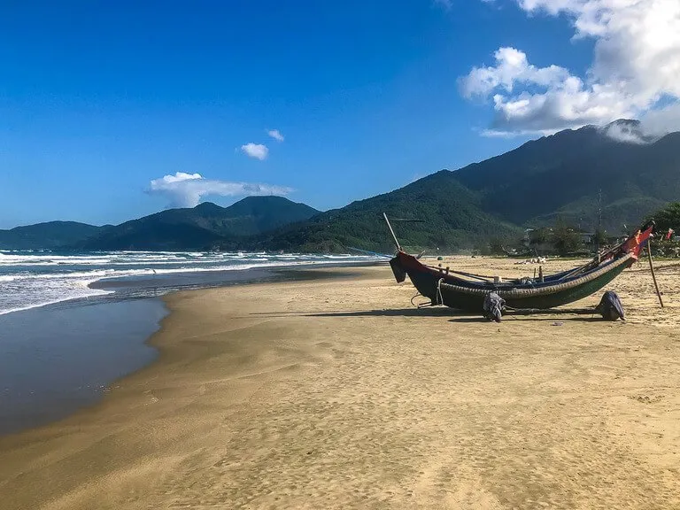 Banana shaped wooden boat on Lang Co beach between hue and Hoi An Vietnam