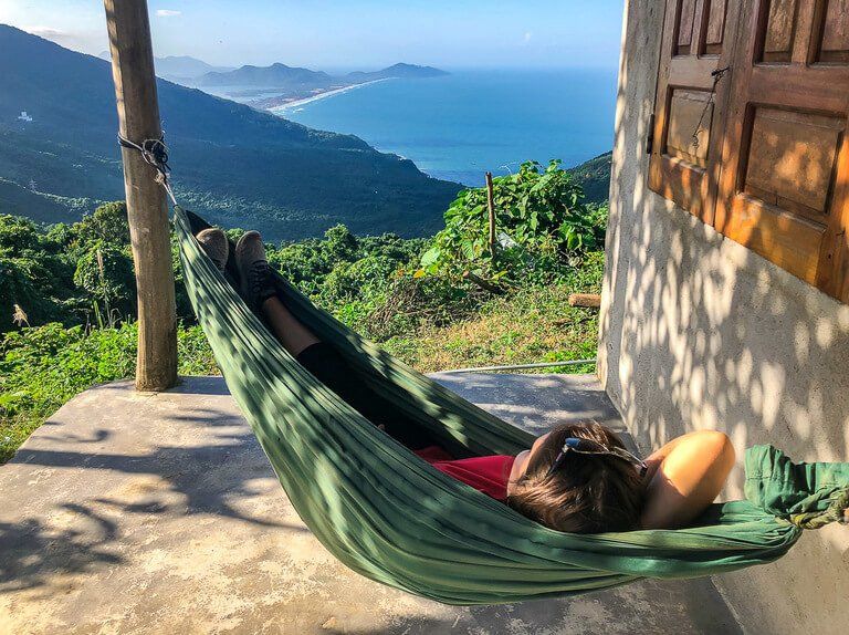 Kristen relaxing in a green hammock with amazing view between hue and Hoi An Vietnam