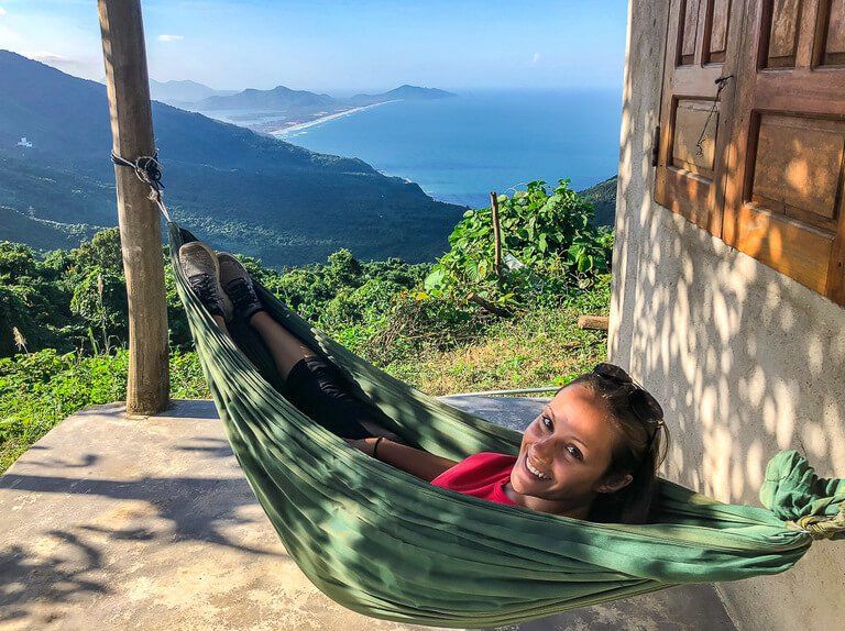 Kristen smiling in hammock with view of Lang Co beach Vietnam
