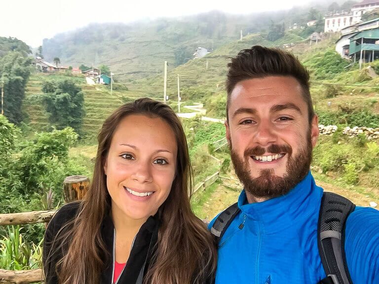 Mark and Kristen in sapa vietnam with rice terraces behind 2 day itinerary