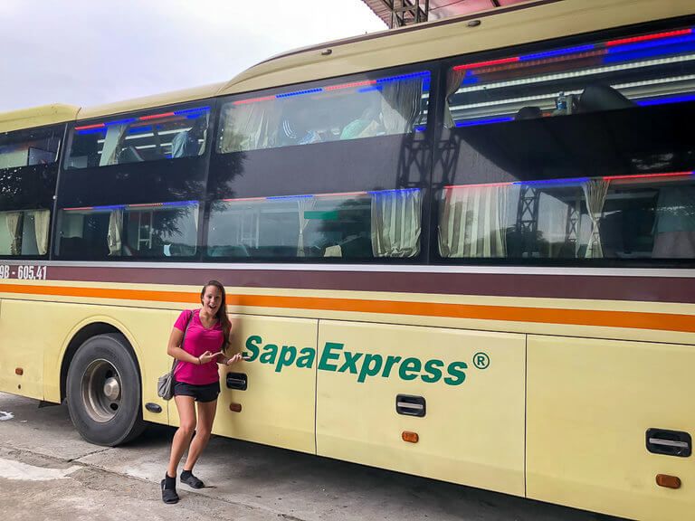 Kristen smiling next to the Sapa Express bus Vietnam