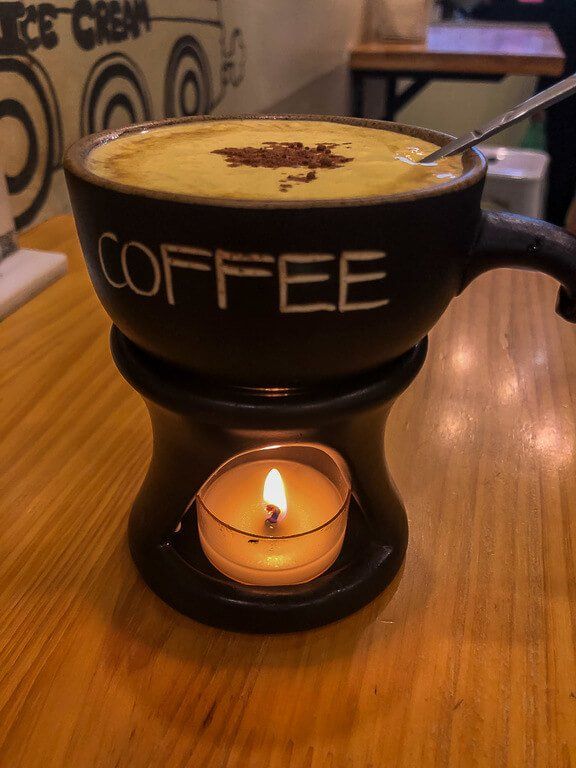 Egg coffee in vietnam with candle below mug