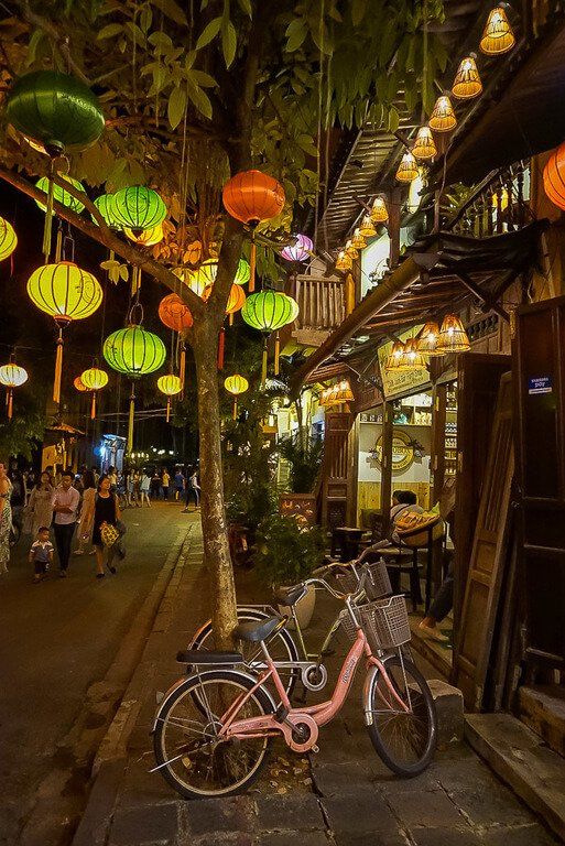 Hoi an at night with lanterns and pink bike against tree lovely atmosphere