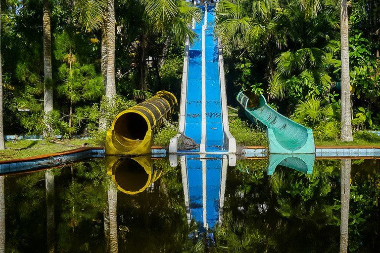 Colorful water slides reflecting in water in hue