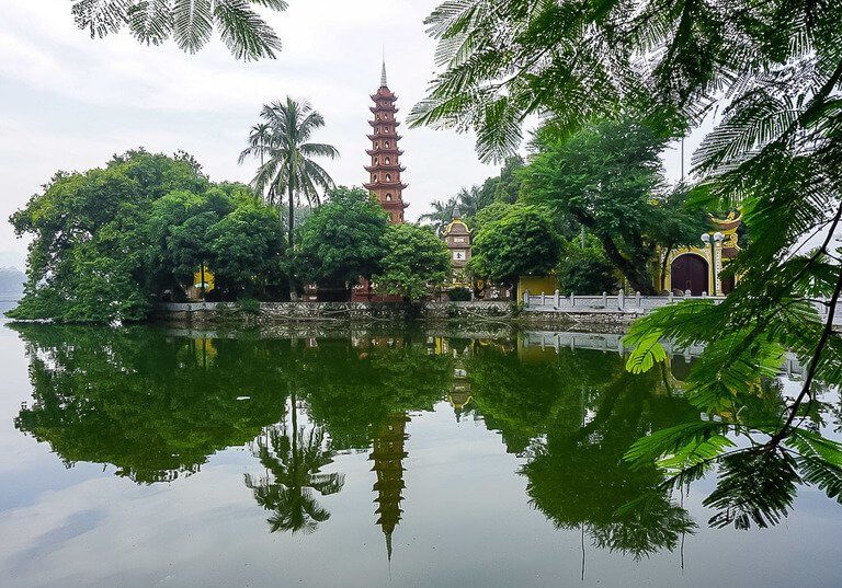 pagoda and reflection in lake in Hanoi Vietnam