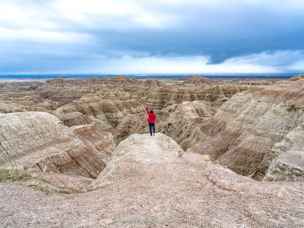 Hiker admiring the view over Badlands national park in South Dakota