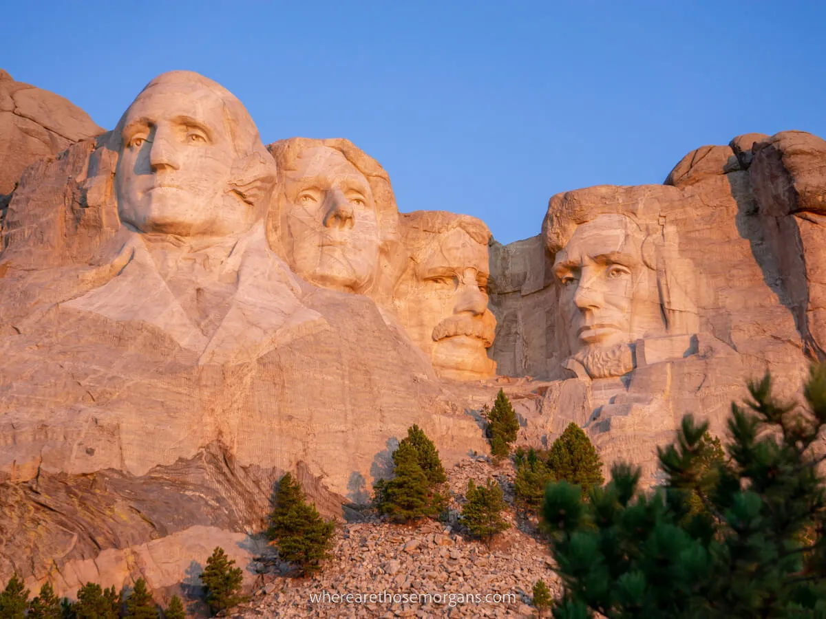 Mount Rushmore in South Dakota glowing pink at sunrise