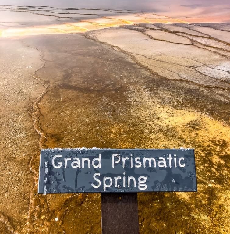 Grand Prismatic Spring sign with colorful hot spring behind