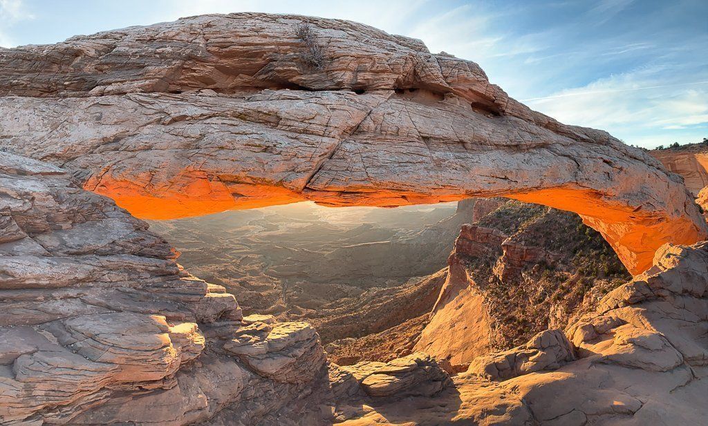 Mesa Arch glowing red just after sunrise in canyonlands national park Utah