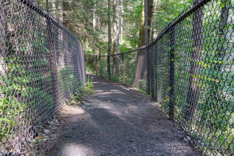 Pathway with fenced gates up at each side of the trail