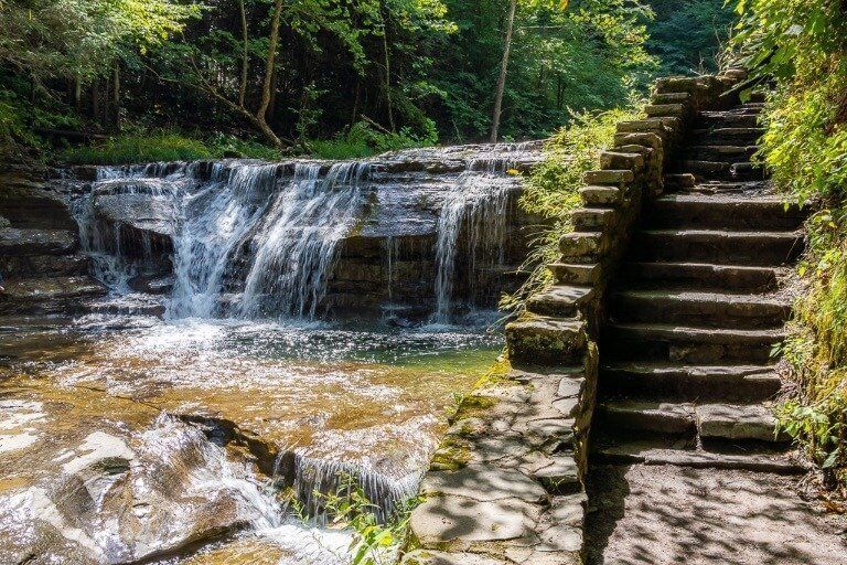 Waterfall and stone staircase at Robert H Treman gorge trail Ithaca NY