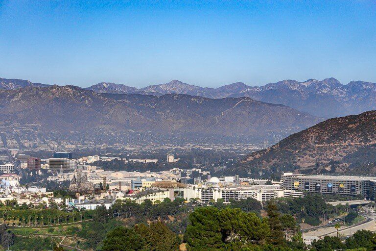 Mulholland Drive in Los Angeles offers elevated views over mountains and city including universal studios