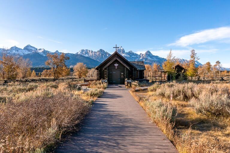 church of the transfiguration wooden boardwalk leading to church and surrounding mountains in grand teton national park wyoming