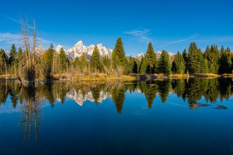 Schwabacher Landing stunning photography location for sunrise at Grand Teton national park inwyoming mountains and trees reflecting
