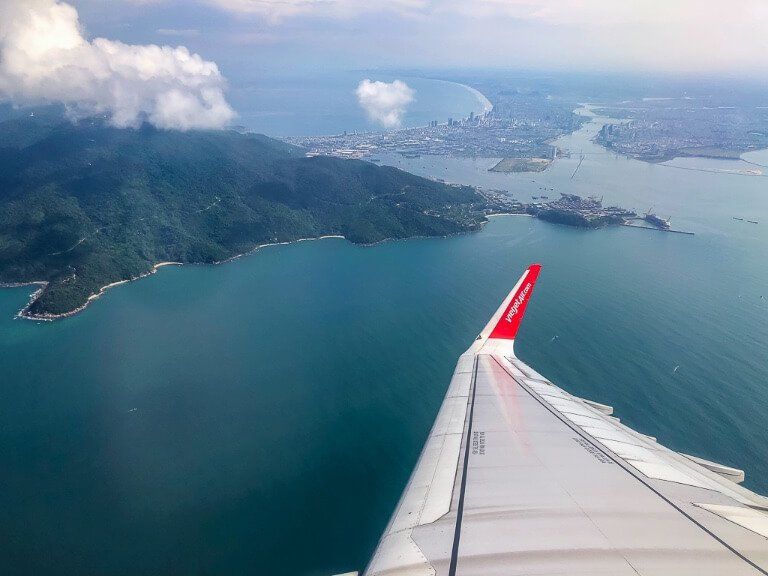 Airplane wing over the ocean and islands on the way from vietnam to hong kong