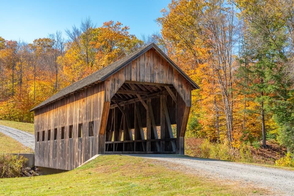 Perfect and picturesque wooden covered bridge in fall foliage gorgeous picture in northeast america
