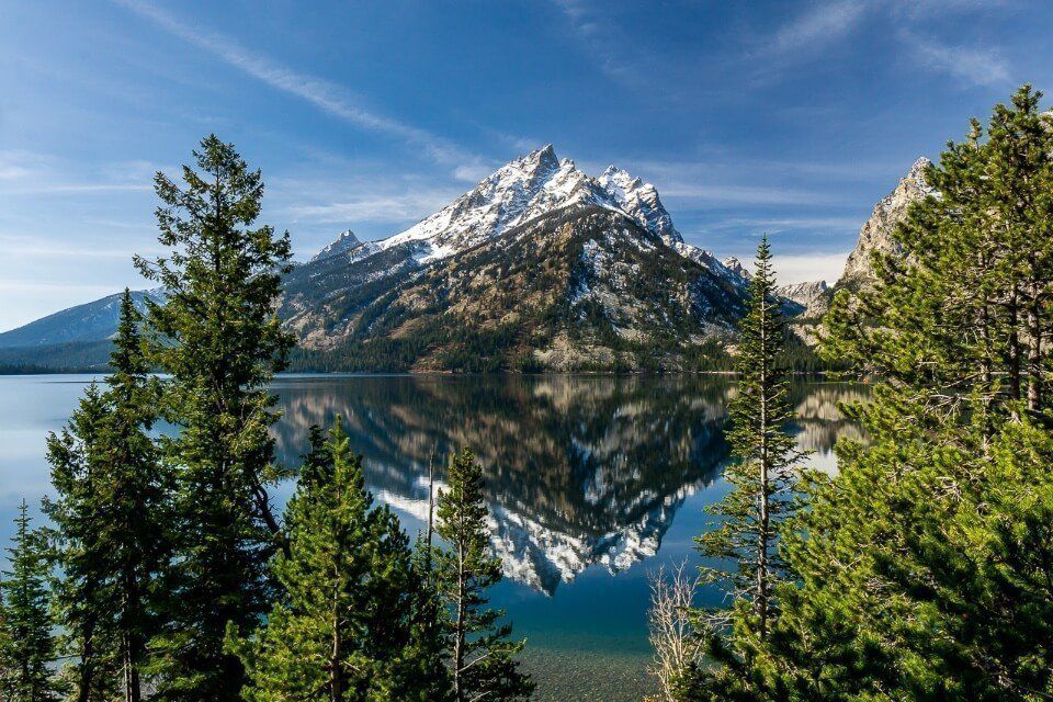 Stunning photo of white capped mountain reflecting in jenny lake at grand teton national park wyoming amazing images of USA landscapes