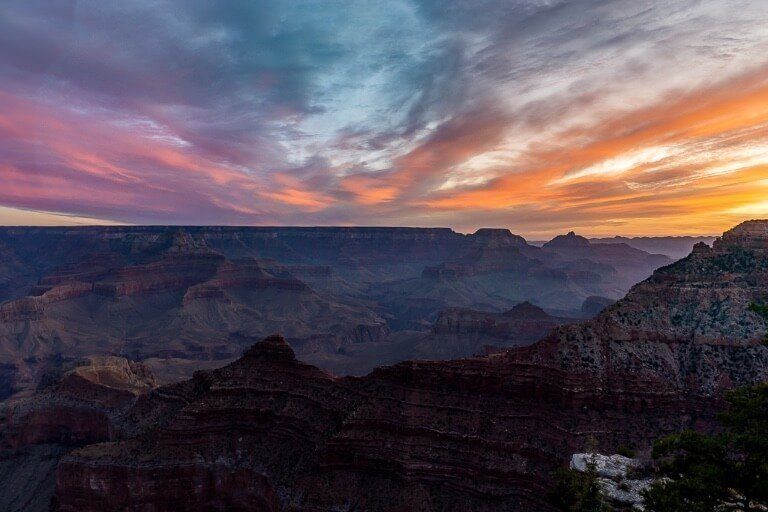 Sunrise at Grand Canyon South Rim Mather Point along the rim with stunning colors in the sky oranges purples pinks