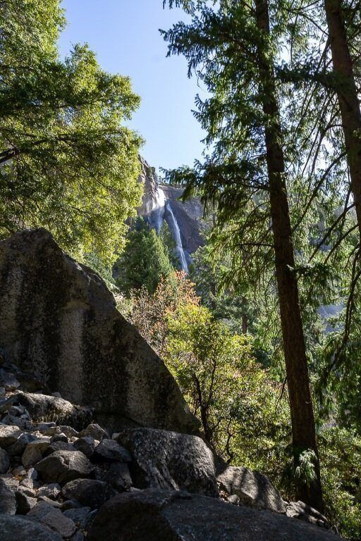 Nevada Fall through trees and rocks on the mist trail yosemite national park