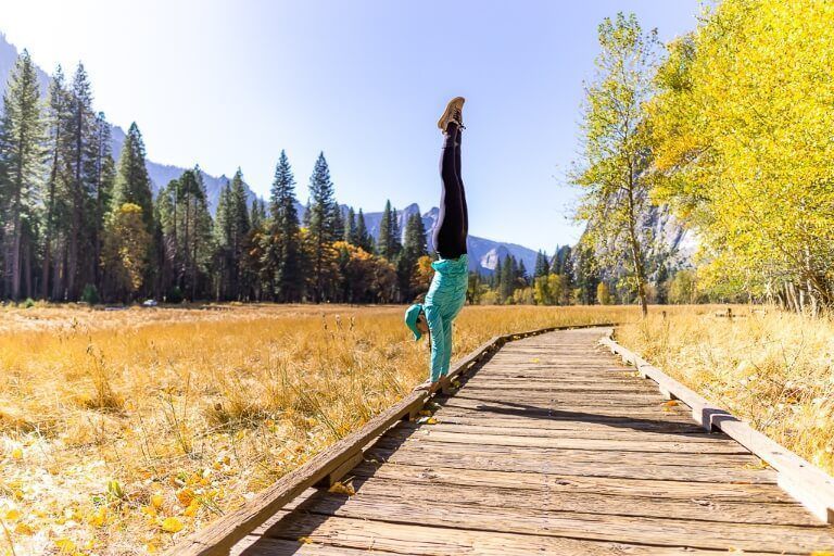 Kristen nailing a perfect handstand on a wooden boardwalk in Yosemite national park cooks meadow loop trail fantastic photography
