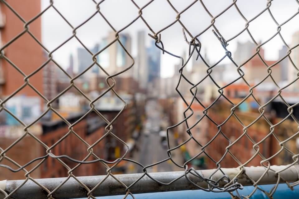 Bokeh hole in fence manhattan bridge photography chinatown nyc