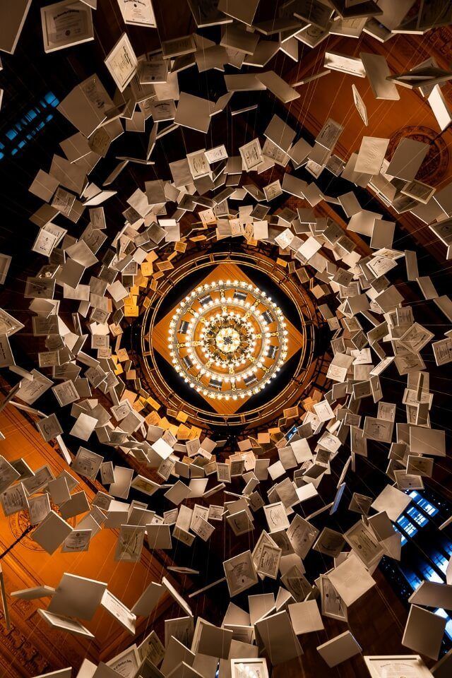 Looking directly up through a spiral of paper in suspension in grand central station new york city