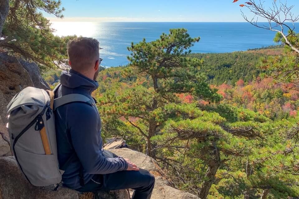 Man looking out over the gorgeous fall foliage in New England