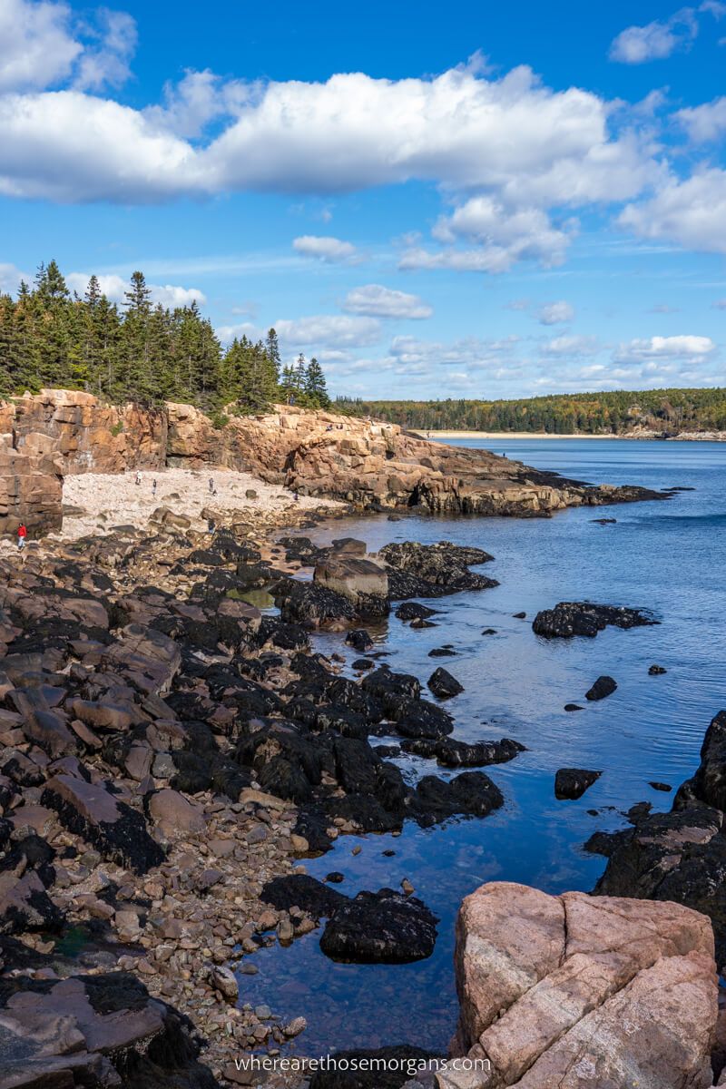 Coastline in Maine with boulders ocean and clouds in sky