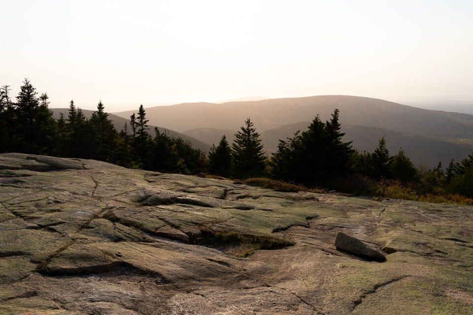 Watching sunset on a hazy day from the top of Cadillac Mountain in Bar Harbor Maine is one of the best things to do in acadia national park