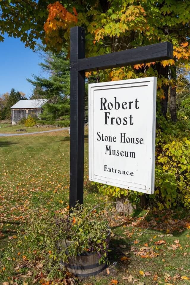 Robert Frost stone house museum sign in fall