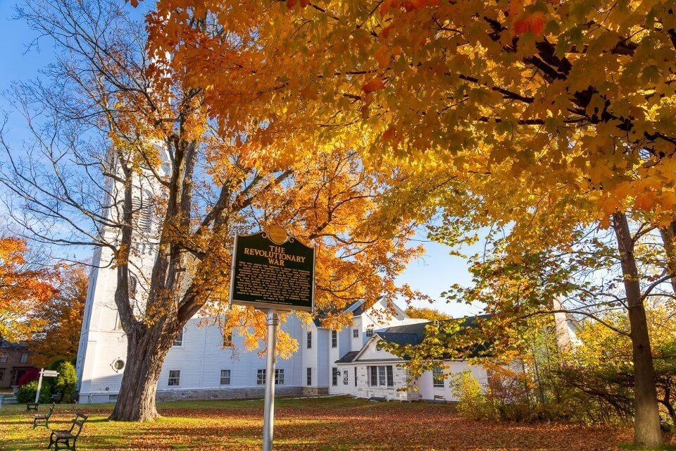 Stunning white church and golden leaves in fall manchester VT best things to do walk around the old town