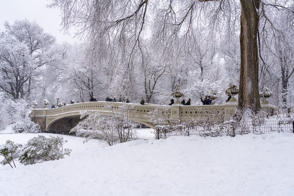 Bow Bridge in snow central park in winter around christmas
