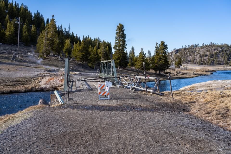 Many hiking trails are closed in yellowstone throughout april due to snow and bear activity like fairy falls with a barricade