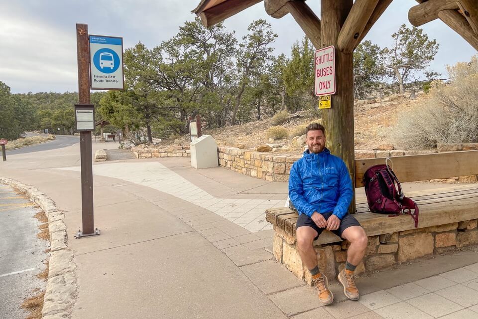 Hiker waiting for blue village shuttle bus in grand canyon south rim