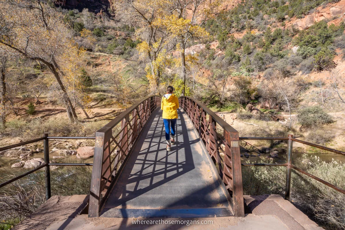 Hiker crossing a bridge over the Virgin River in Zion