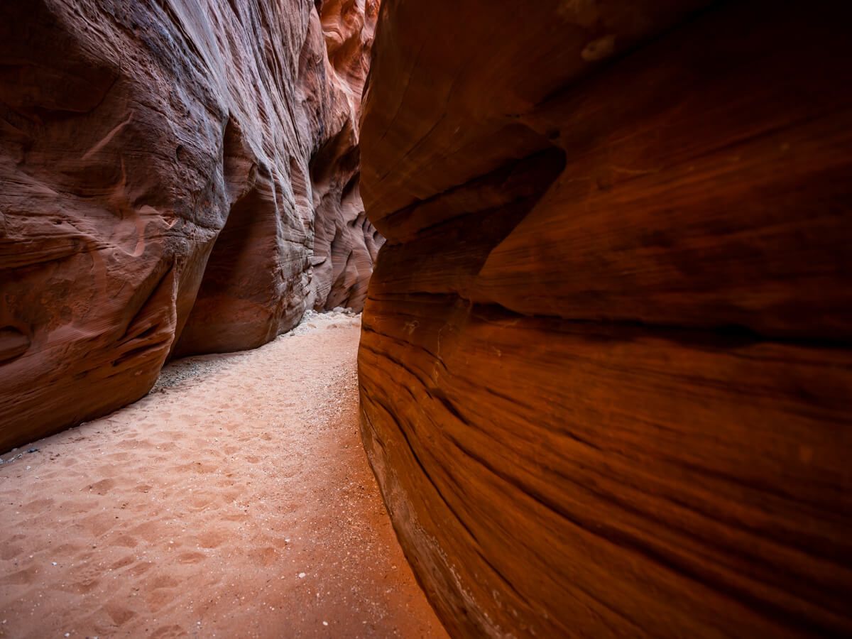 Buckskin Gulch day hike from Wire Pass trailhead sandy trail through longest slot canyon in the United States narrow canyon walls orange sandstone