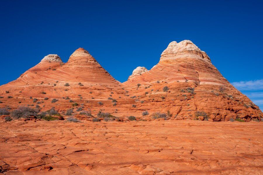 Teepee dome formations on a trail in utah with blue sky